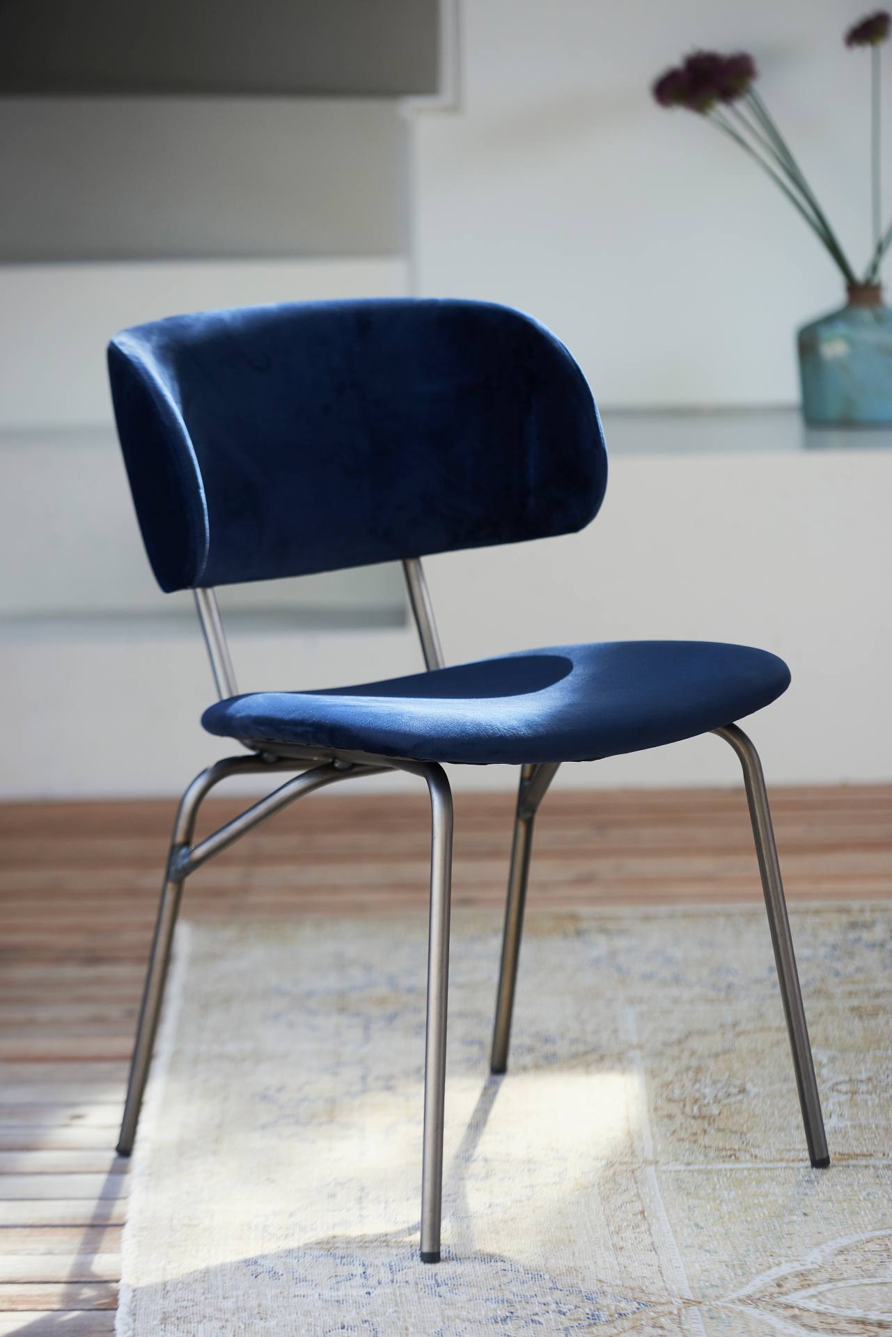 Der moderne Stuhl Giulia wurde aus einem Metall Gestell gefertigt. Die Sitz- und Rückenfläche ist aus einem Samt Bezug. Der Stuhl hat eine dunkelblaue Farbe und ist von der Marke Jan Kurtz.